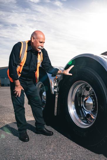 National Workshop Manager Andy Mickan inspects the Bridgestone M866 tyres.
