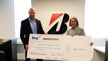 Bridgestone New Zealand’s Tim Southey presents LBC’s Annabel Lush with the Drive for a Cure proceeds.