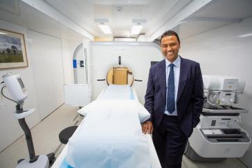 Heart of Australia Founder, Dr Rolf Gomes, with the world’s first battery powered CT scanner on board the recently launched HEART 5 truck.